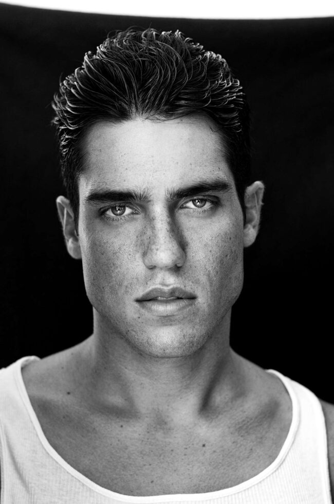 Aspiring male model reading up on 'how to become a male model', Young man working on his portfolio, a key step in how to become a male model, Fitness training for male models, integral to learning how to become a male model, Photo shoot focusing on style, essential for aspiring male models, Male model practicing runway techniques, a part of how to become a male model, Behind-the-scenes at a photo shoot with a budding male model, Casting call attendance, a crucial move in becoming a male model, Personal grooming tips for aspiring male models, Headshot session for a male model portfolio, an important step, Fashion industry networking, a vital aspect of how to become a male model