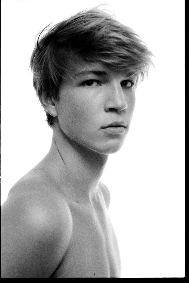 Aspiring male model reading up on 'how to become a male model', Young man working on his portfolio, a key step in how to become a male model, Fitness training for male models, integral to learning how to become a male model, Photo shoot focusing on style, essential for aspiring male models, Male model practicing runway techniques, a part of how to become a male model, Behind-the-scenes at a photo shoot with a budding male model, Casting call attendance, a crucial move in becoming a male model, Personal grooming tips for aspiring male models, Headshot session for a male model portfolio, an important step, Fashion industry networking, a vital aspect of how to become a male model