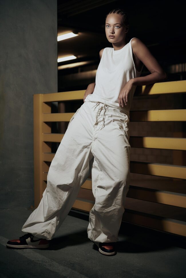 Aspiring model reading a guide on 'how to become a model', Photo session for a modeling portfolio, a step in learning how to become a model, New face at a modeling agency, following tips on how to become a model, Fashion shoot, part of the process in how to become a model, Model in training practicing runway walk, essential for how to become a model, Behind-the-scenes look at a model's preparation, key to becoming a model, Aspiring model attending a casting call, a step towards becoming a model, Fitness regime for models, an aspect of how to become a model, Portfolio review, a crucial phase in how to become a model, Model receiving coaching on posing techniques, important for aspiring models