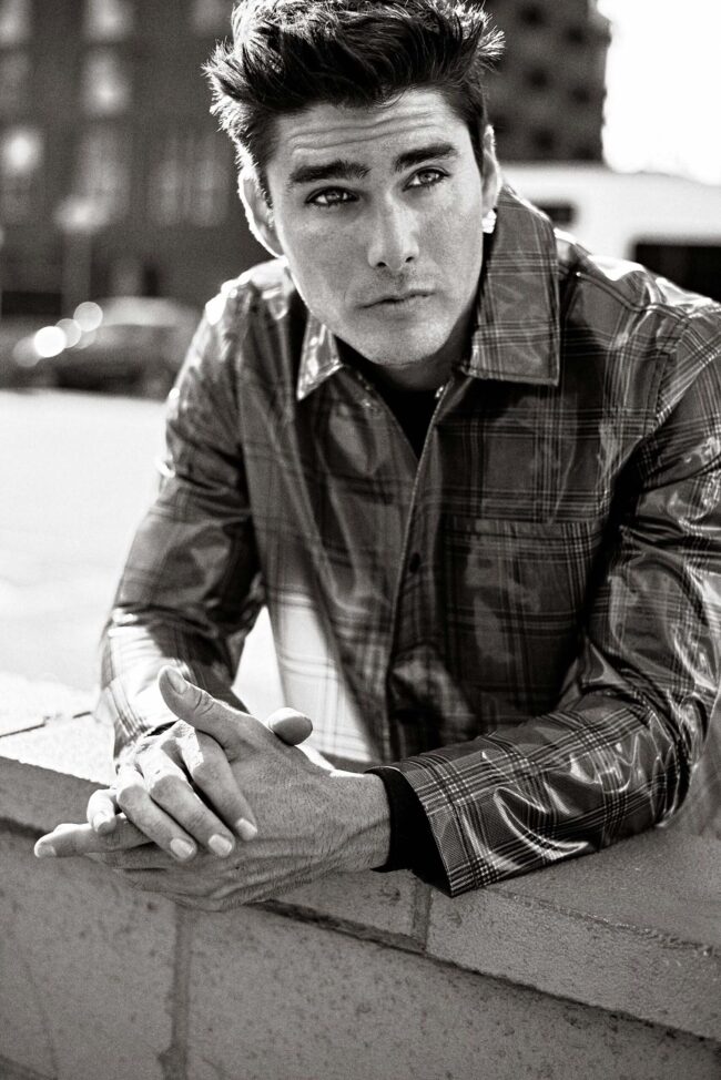 Los Angeles fashion photographer, black and white menswear image of a male model in a plaid jacket photographed in close-up with natural light, editorial portrait for fashion brands, lookbooks, and digital marketing.