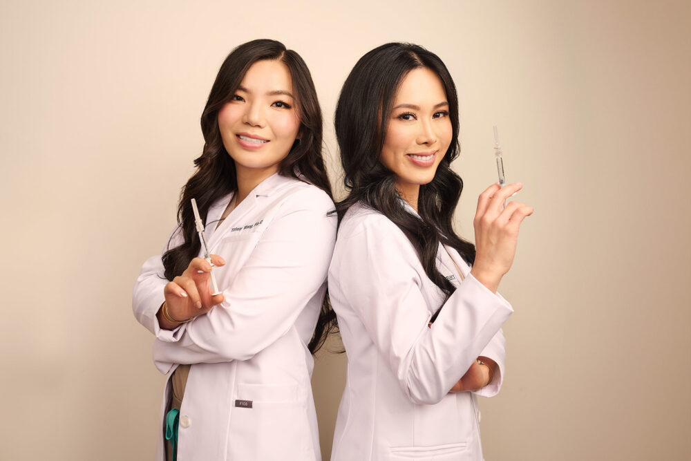Social media photographer in Los Angeles, two aesthetic medicine professionals in white coats holding syringes, branded content photo for medical spa marketing, Instagram, websites, and digital campaigns.